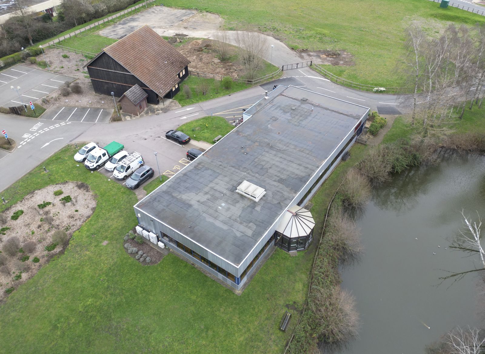 Drone photograph of a large flat commercial roof with a rooflight